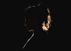 Profil einer Frau im Dunkeln soll Konzentration symbolisieren